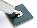 Applying thermal grease paste on a computer cpu processor Royalty Free Stock Photo