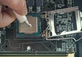 Applying thermal paste during CPU installation close up in the motherboard Royalty Free Stock Photo