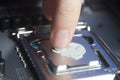 Applying thermal paste with finger in CPU on motherboard Royalty Free Stock Photo