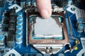 Applying thermal paste with finger during Processor Intel i5 installation on motherboard Royalty Free Stock Photo