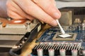 Applying thermal paste to the video processor. close-up Royalty Free Stock Photo