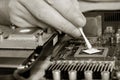 Applying thermal paste to the video processor. Royalty Free Stock Photo