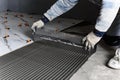 Applying tile glue to the floor using a tiling comb. Royalty Free Stock Photo