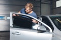 Applying tinting foil onto a car window Royalty Free Stock Photo