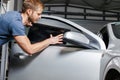 Applying tinting foil onto a car window Royalty Free Stock Photo