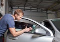 Applying tinting foil onto a car window Royalty Free Stock Photo