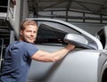 Applying tinting foil onto a car window Royalty Free Stock Photo