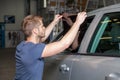 Applying tinting foil onto a car window Royalty Free Stock Photo