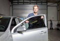 Applying tinting foil onto a car window Royalty Free Stock Photo