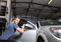 Applying tinting foil onto a car window Royalty Free Stock Photo