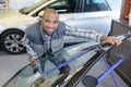 Applying tinting foil onto car window in workshop Royalty Free Stock Photo