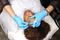 Applying Tottoo, Brow Microblading to customer eyebrows Royalty Free Stock Photo