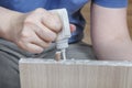 Applying wood glue, carpenter gluing wooden parts for furniture, close-up. Royalty Free Stock Photo