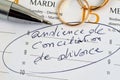 Divorce Conciliation Hearing written on diary with wedding rings and pen close up