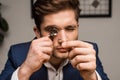 Appraiser with magnifying glass examining jewelry