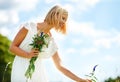 Appreciating the beauty of the countryside. Cropped view of a young woman picking flowers outdoors. Royalty Free Stock Photo