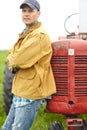 Appreciating nature. a farmer standing next to his tractor with his arms crossed. Royalty Free Stock Photo