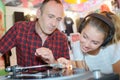 Apprehensive man watching teenager play vinyl record