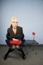 Apprehensive woman sitting waiting in an office Royalty Free Stock Photo