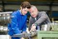 Apprentice being shown how to cut sheet metal