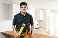 Apprentice Carpenter Installing Luxury Fitted Kitchen Royalty Free Stock Photo