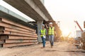 Apprentice and Civil Engineer at Road Construction Site, Industrial Building Construction Site. In the Background Crane, Royalty Free Stock Photo