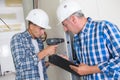Apprentice construction worker drilling wall Royalty Free Stock Photo
