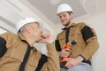 Apprentice construction worker at site with instructor