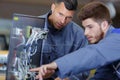 Apprentice electrician asking tutor about wiring Royalty Free Stock Photo