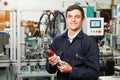 Apprentice Engineer Checking Component In Factory Royalty Free Stock Photo