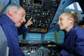 apprentice engineer in stationary aircraft cockpit with supervisor Royalty Free Stock Photo