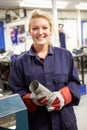 Apprentice Engineer Working On Factory Floor