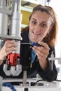 Apprentice Female Engineer Working On Machine In Factory Royalty Free Stock Photo