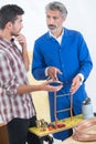 Apprentice learning about copper pipe fittings with instructor Royalty Free Stock Photo