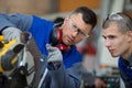 apprentice learning how to use circular saw Royalty Free Stock Photo