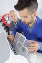 Apprentice learns to clean air conditioning filter Royalty Free Stock Photo