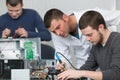 Apprentice male technician soldering lan switch router Royalty Free Stock Photo