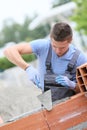 Apprentice of masonry laying bricks Royalty Free Stock Photo