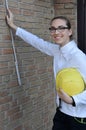 Female trainee measures a wall