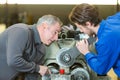Apprentice mending lathe machine Royalty Free Stock Photo