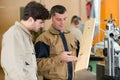 Apprentice with teacher in carpentry school