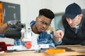 Apprentice and teacher during electronic wood cutting machine