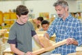 apprentice and teacher fitting wood