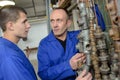 Apprentice and teacher next to gas pipes Royalty Free Stock Photo