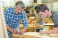 apprentice and teacher working with wood Royalty Free Stock Photo