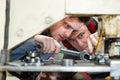 apprentice technician learning to tighten bolt with spanner