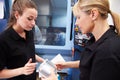 Apprentice Working With Female Engineer On CNC Machinery Royalty Free Stock Photo