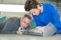 Apprentice working with teacher in metalworks factory