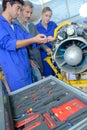 Apprentices aeronautical engineers learning with their professor Royalty Free Stock Photo