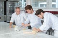 Apprentices learning with baker master Royalty Free Stock Photo
